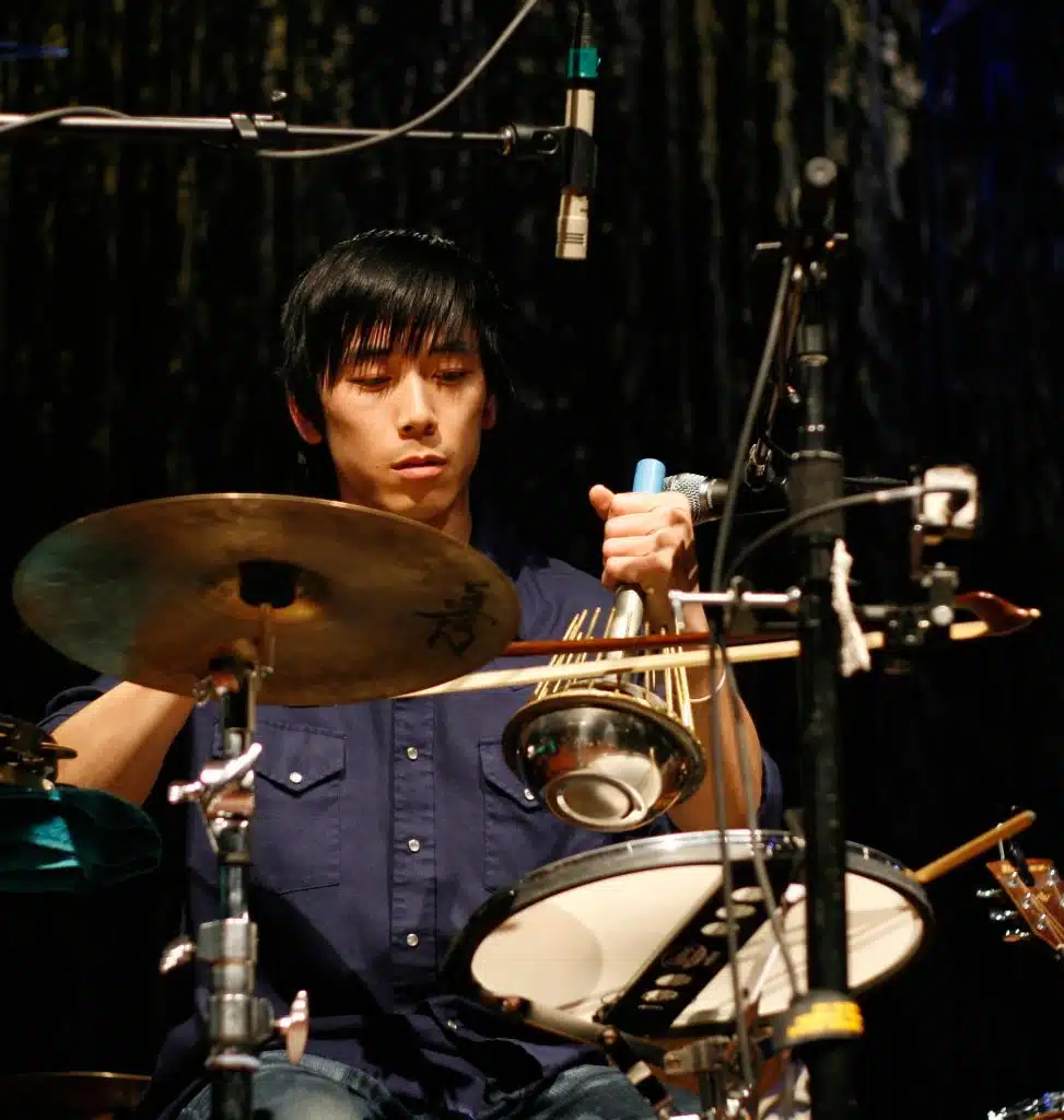 Percussionist Alex Wong playing an uncommon instrument, the waterphone with a bow.