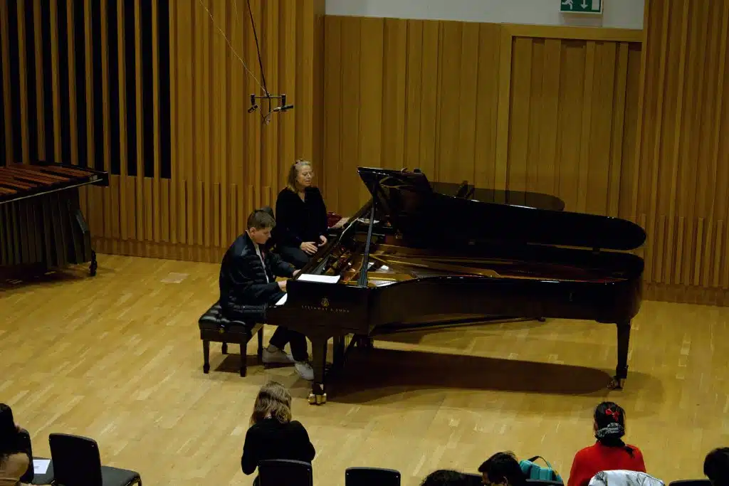 Kathryn Stott and a young musician at Young Sounds UK's Thrive Piano Masterclass at Chetham's School of Music